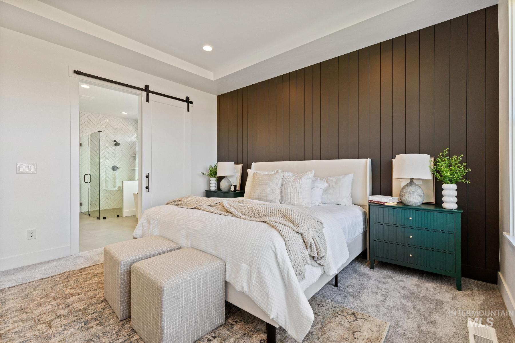 8650 West Inspirado Street Meridian, ID 83646 - Photo 22 of 30 Bedroom featuring a barn door, light carpet, an accent wall, recessed lighting, and wood walls