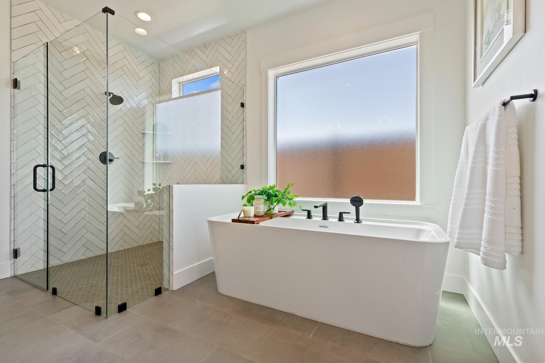 8650 West Inspirado Street Meridian, ID 83646 - Photo 28 of 30 Bathroom featuring a soaking tub, a shower stall, and recessed lighting