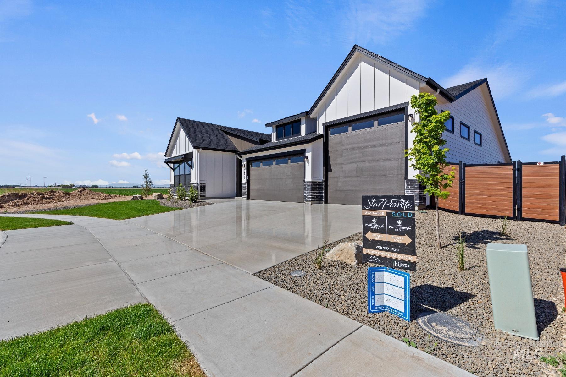 8650 West Inspirado Street Meridian, ID 83646 - Photo 4 of 30 Modern farmhouse style home featuring board and batten siding, driveway, and a garage