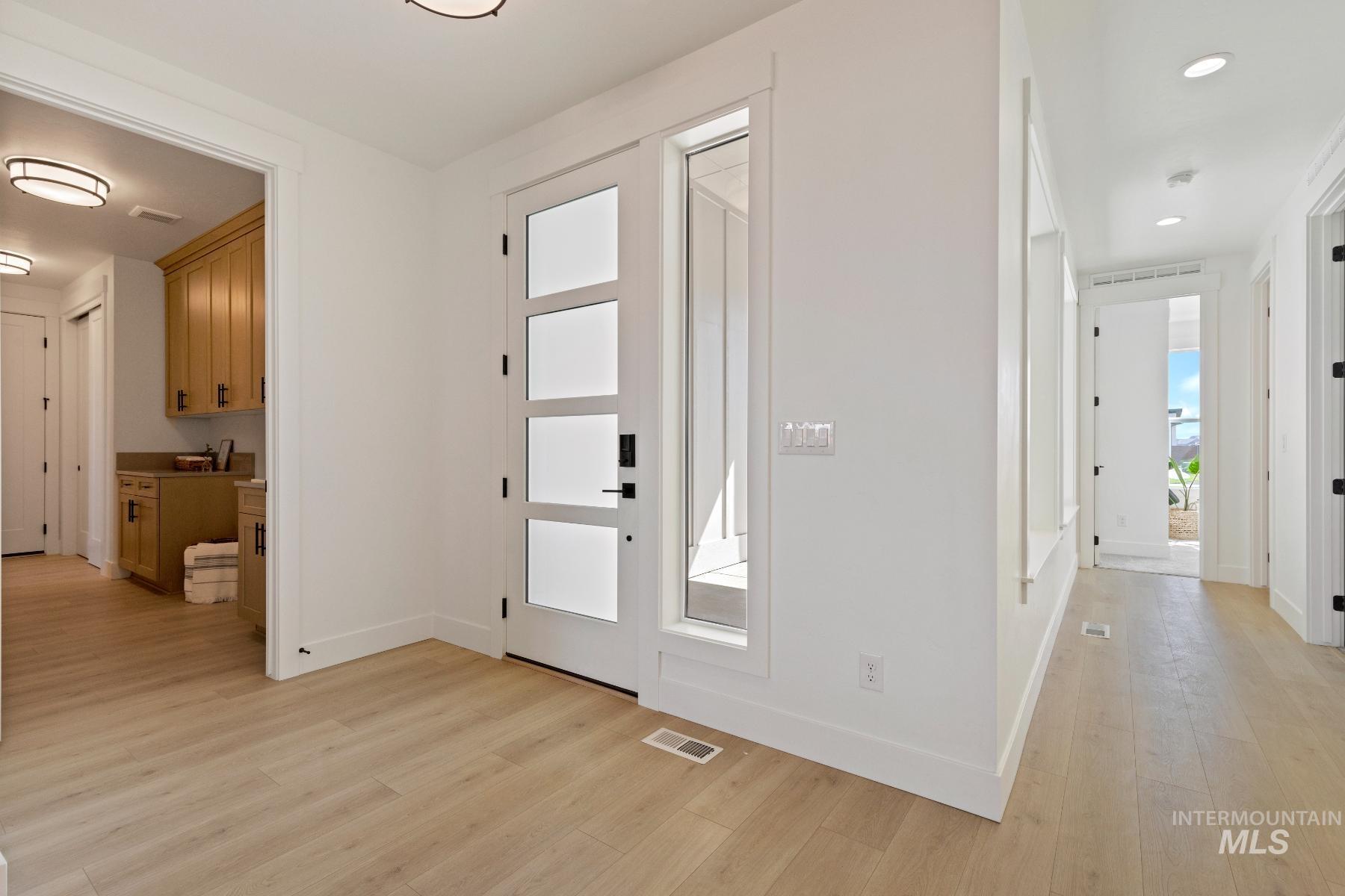 8650 West Inspirado Street Meridian, ID 83646 - Photo 7 of 30 Foyer entrance featuring light wood-type flooring and baseboards