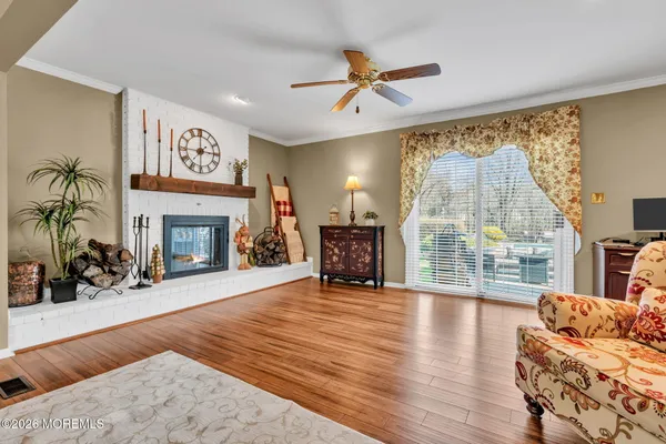 a view of a dining room with furniture wooden floor and chandelier