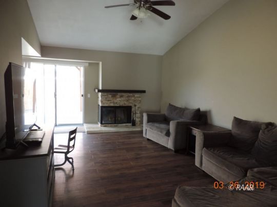 627 North Rio Bravo Street Ridgecrest, CA 93555 - Photo 4 of 6 a living room with furniture and a fireplace