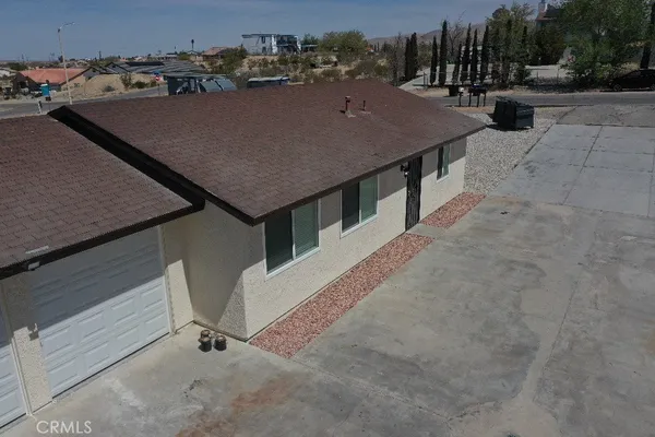 an aerial view of a house with table and chairs