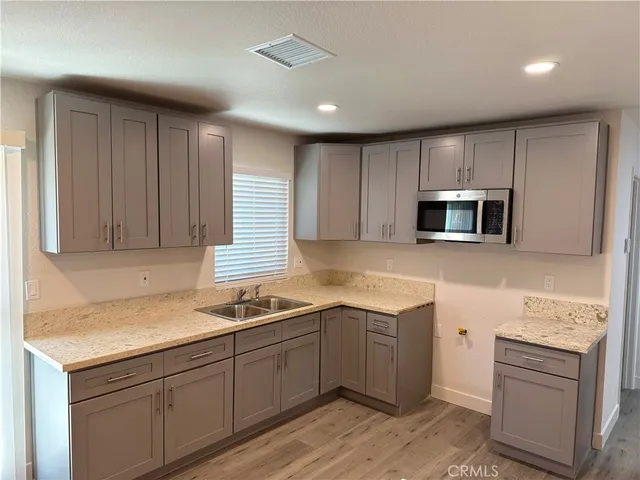 a kitchen that has a sink and a stove in it