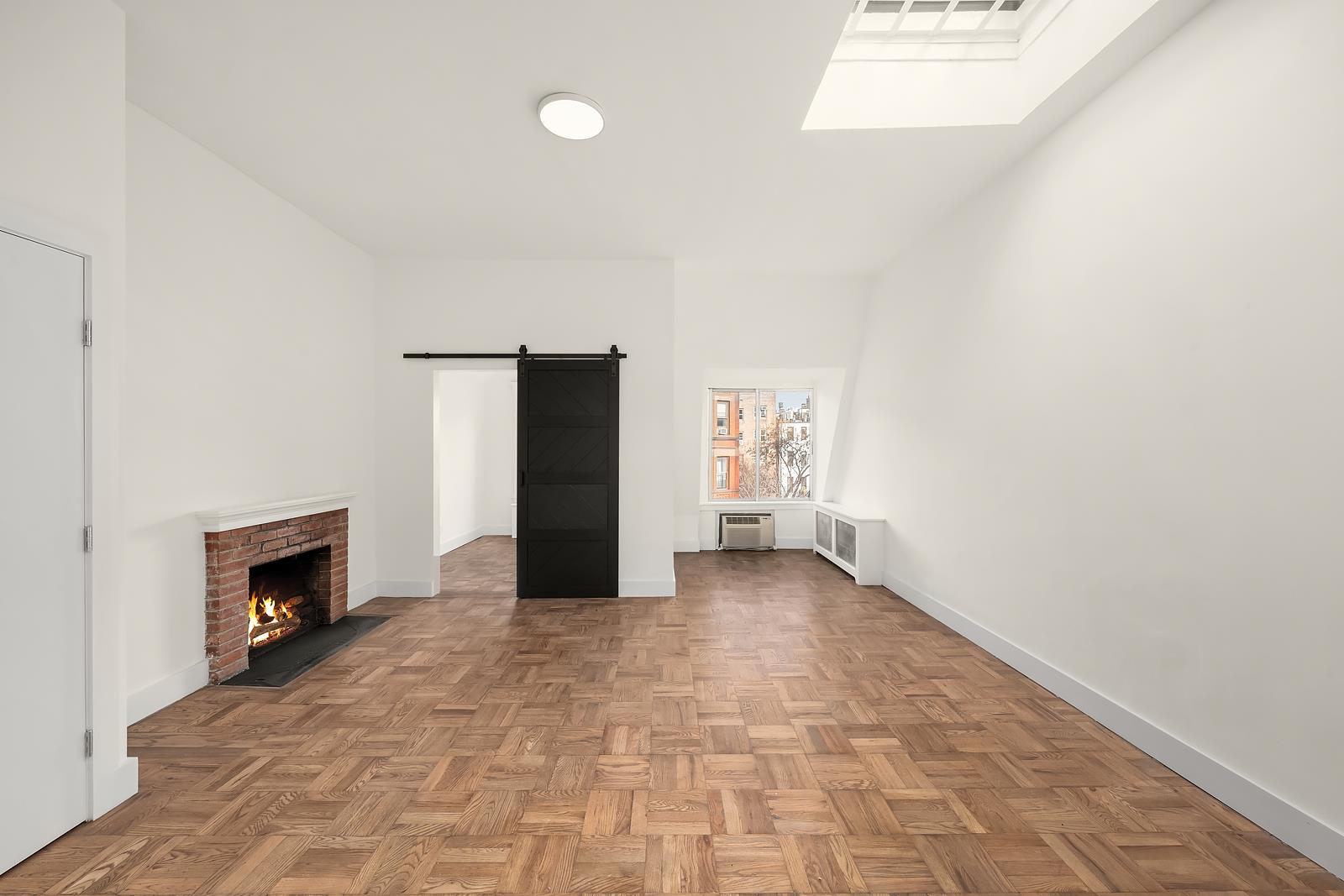 a view of empty room with a fireplace