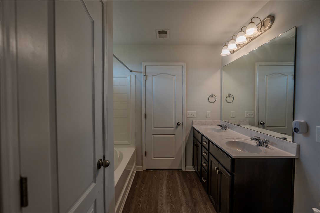 102 Talisker Way Greenville, SC 29607 - Photo 16 of 18 This bathroom features a double vanity and soaking tub, offering both convenience and relaxation.