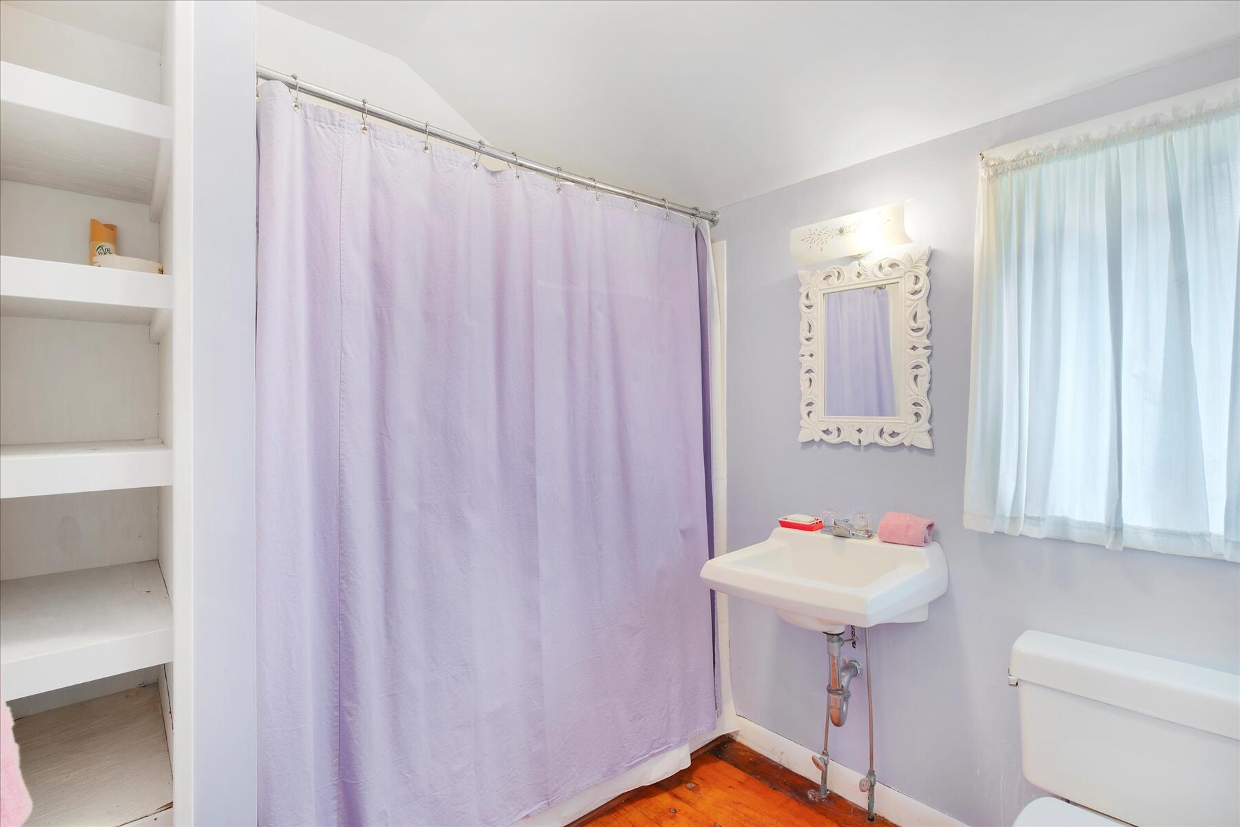 35 Valley Avenue Centerville, MA 02632 - Photo 18 of 37 a bathroom with a sink a bath tub and a shower curtain
