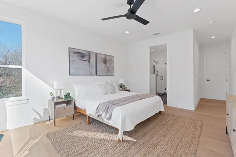 a bedroom with a bed and a painting on the wall