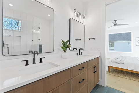 a bathroom with double vanity sink and mirror