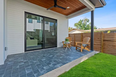a view of a porch with chairs and backyard