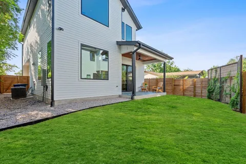 a view of a house with a backyard