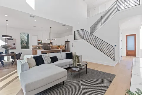 a living room with furniture a rug and white walls