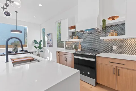 a kitchen with sink cabinets and stove