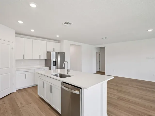 a kitchen with a sink microwave and cabinets