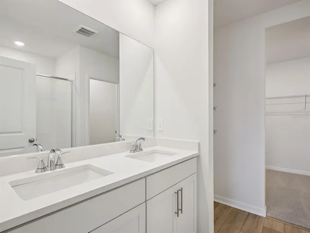 a bathroom with 2 sink and a mirror