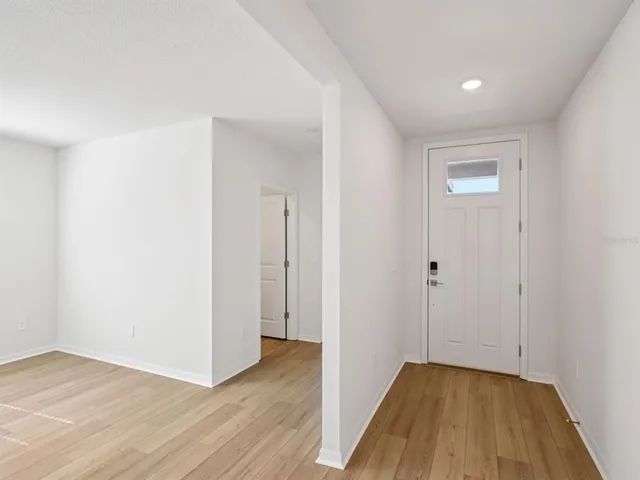 a view of hallway with wooden floor
