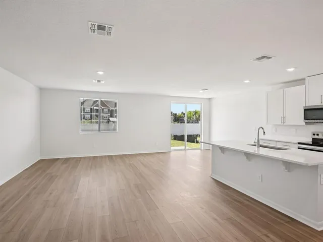 a view of kitchen with sink and wooden floor