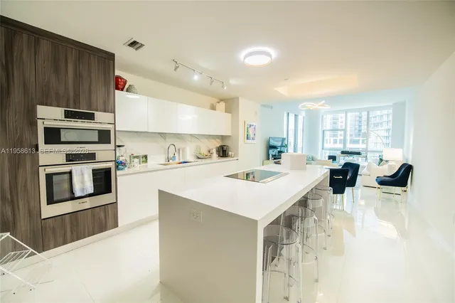 a large kitchen with a large counter top appliances and cabinets