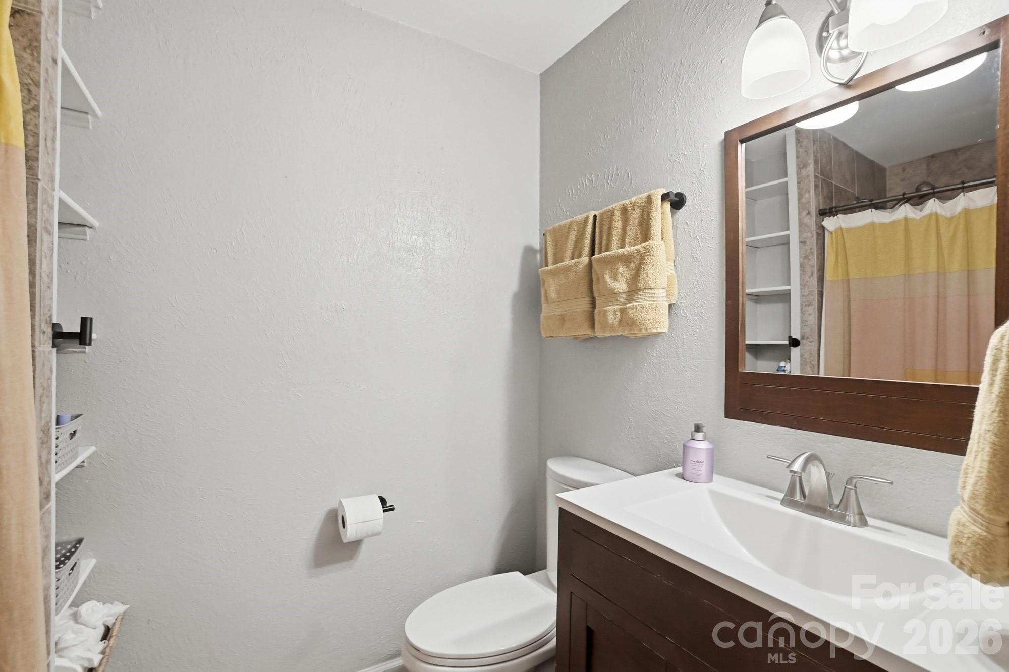 824 Riverwood Road Charlotte, NC 28270 - Photo 18 of 37 a bathroom with a granite countertop sink toilet and mirror