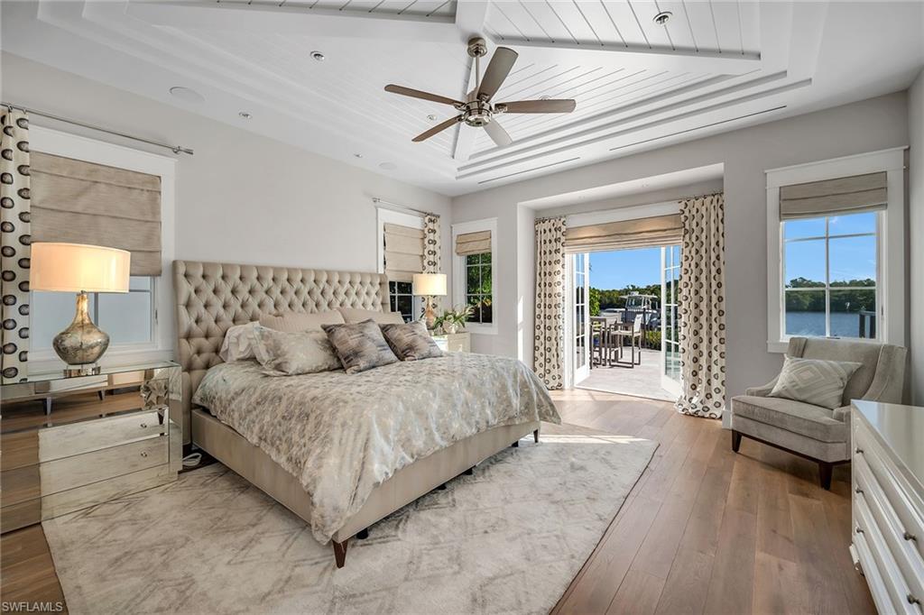 185 15th Street South Naples, FL 34102 - Photo 12 of 49 a bedroom with a large bed couch and a window