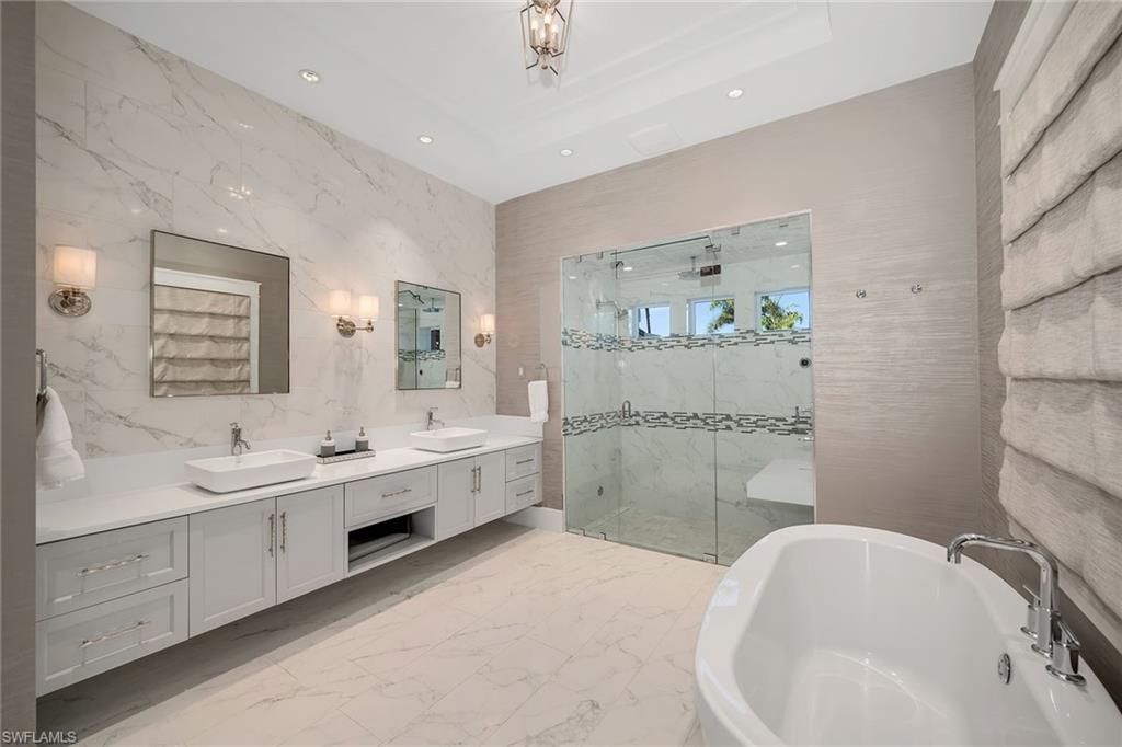 185 15th Street South Naples, FL 34102 - Photo 14 of 49 a bathroom with a double vanity sink mirror and bathtub