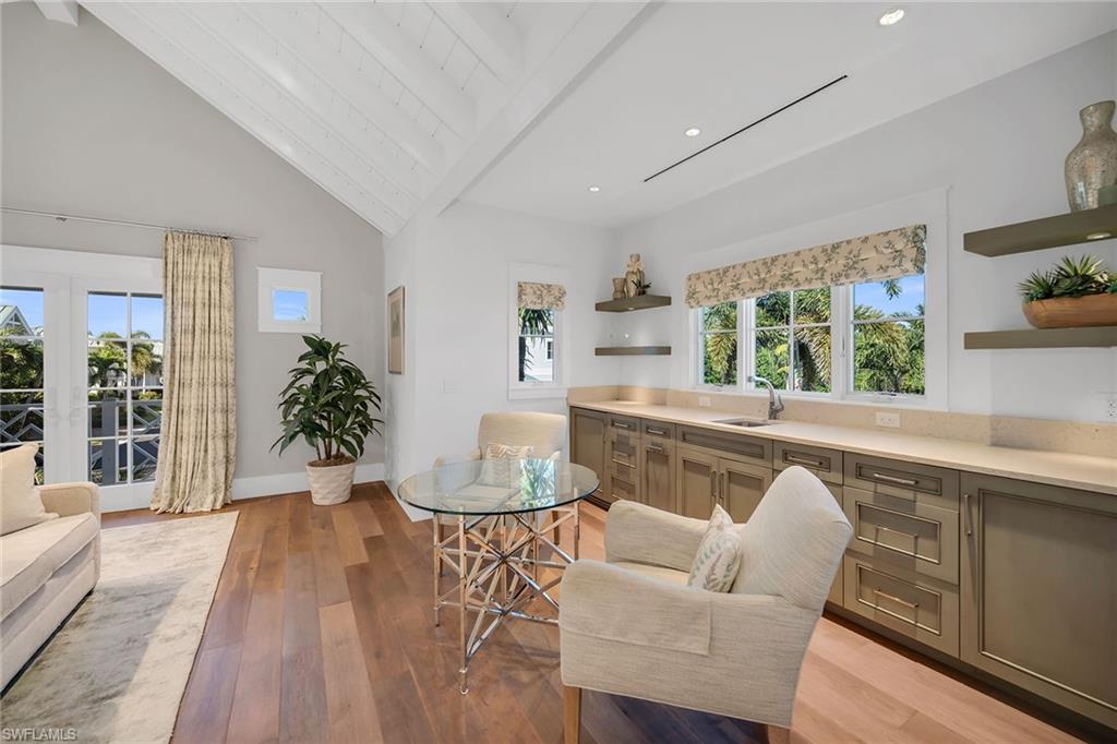 185 15th Street South Naples, FL 34102 - Photo 22 of 49 a living room with furniture and a large window