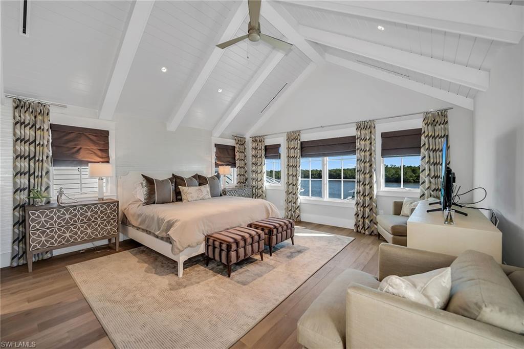 185 15th Street South Naples, FL 34102 - Photo 25 of 49 a spacious bedroom with a bed couch and window