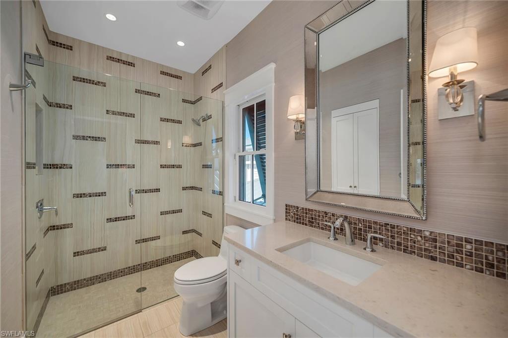 185 15th Street South Naples, FL 34102 - Photo 27 of 49 a bathroom with a sink a toilet and shower