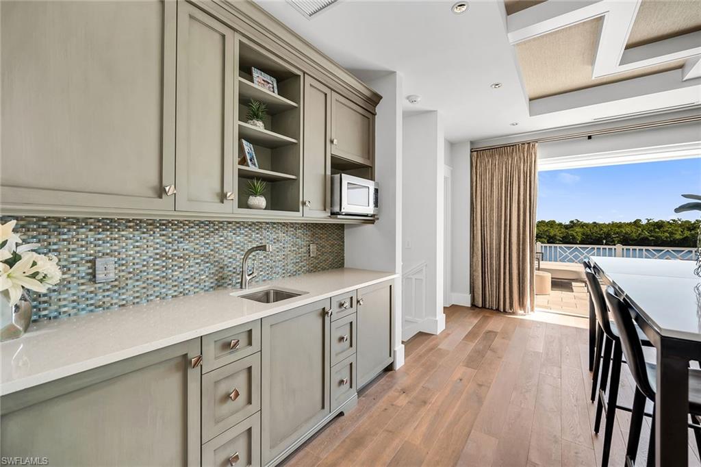 185 15th Street South Naples, FL 34102 - Photo 32 of 49 a kitchen with a sink and cabinets