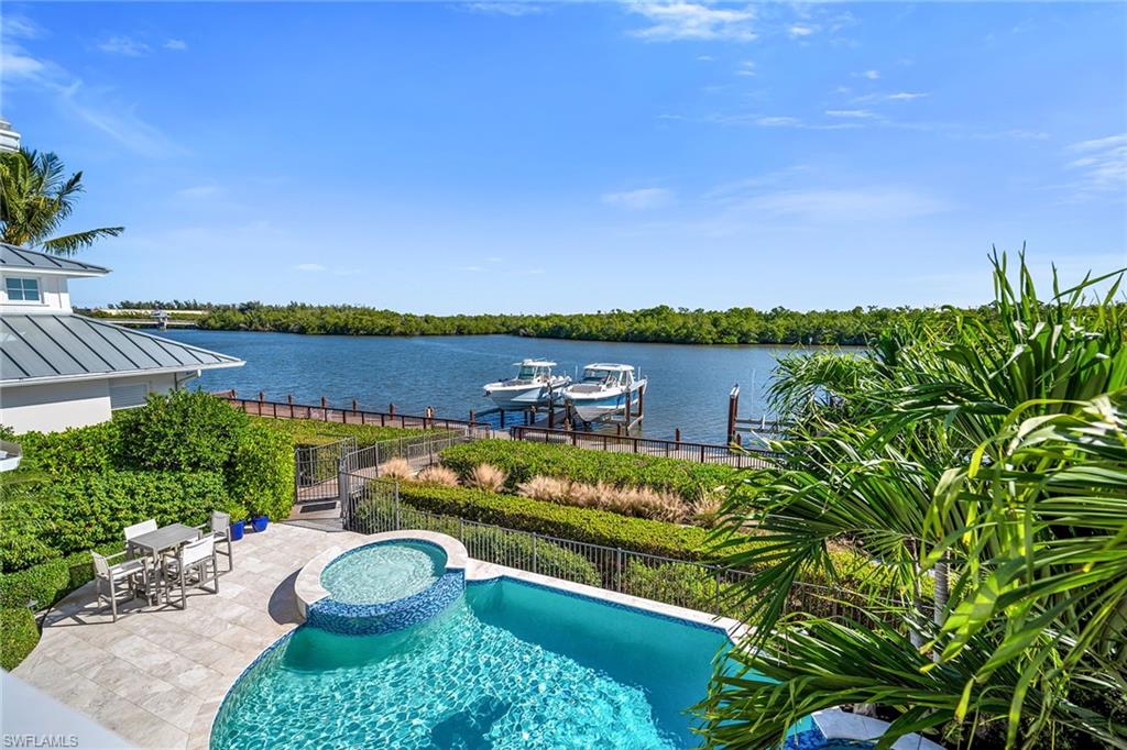 185 15th Street South Naples, FL 34102 - Photo 35 of 49 a view of a lake with houses in the back