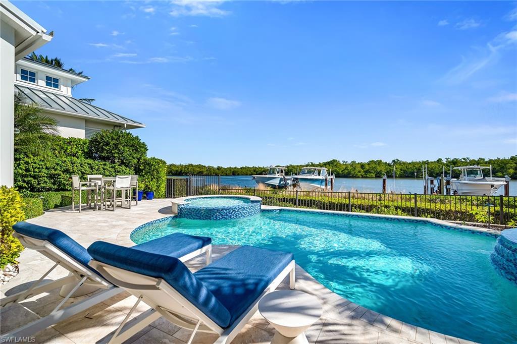 185 15th Street South Naples, FL 34102 - Photo 41 of 49 a view of swimming pool with outdoor seating and yard