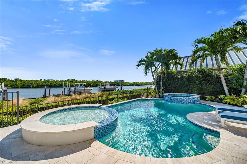 185 15th Street South Naples, FL 34102 - Photo 42 of 49 a view of a swimming pool with a patio