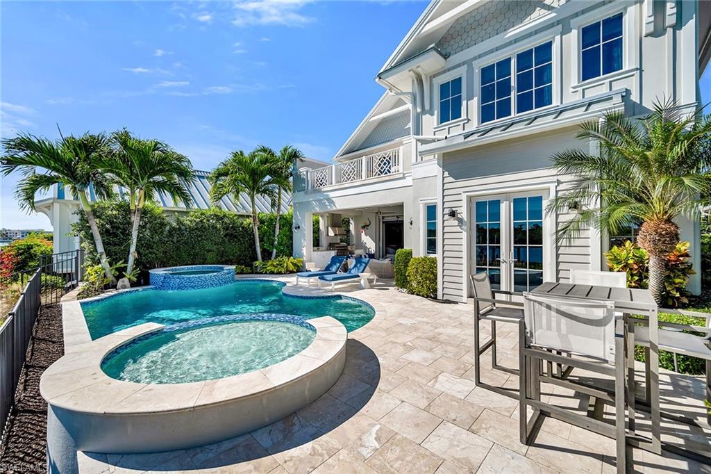 185 15th Street South Naples, FL 34102 - Photo 43 of 49 a view of a house with swimming pool and sitting area