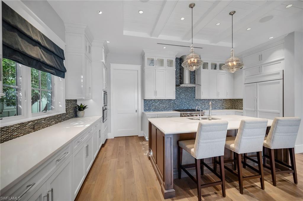 185 15th Street South Naples, FL 34102 - Photo 5 of 49 a large kitchen with a table and chairs in it
