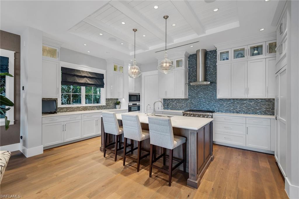 185 15th Street South Naples, FL 34102 - Photo 8 of 49 a large kitchen with a table and chairs