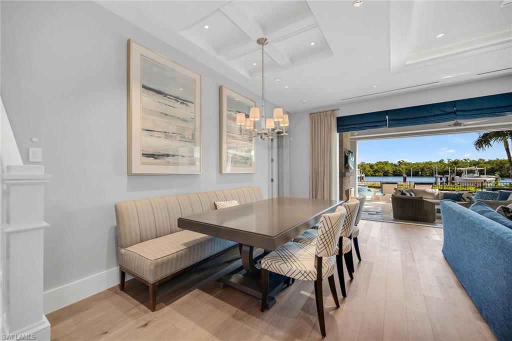 185 15th Street South Naples, FL 34102 - Photo 10 of 49 a dining room with furniture and a floor to ceiling window