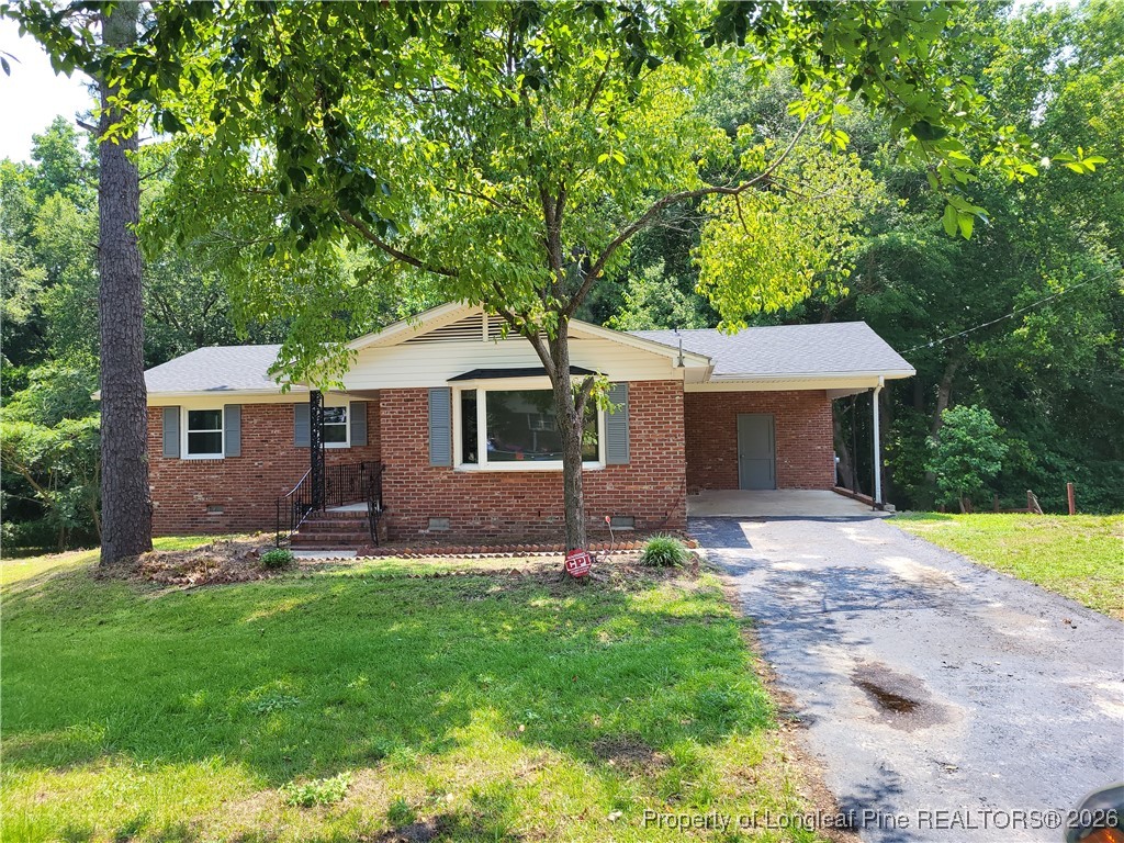 182 Summerhill Road Fayetteville, NC 28303 - Photo 2 of 24 a front view of a house with a garden