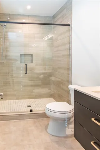 a bathroom with a toilet and a shower