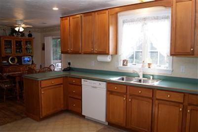124 Captain Samadrus Road Cotuit, MA 02635 - Photo 9 of 18 a kitchen with stainless steel appliances granite countertop cabinets sink and window