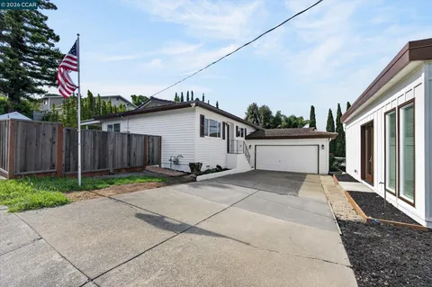 a view of a yard with large trees and stairs