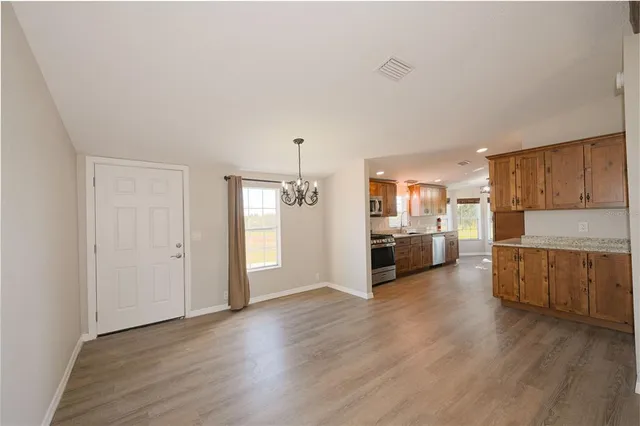 a kitchen with sink stove and refrigerator