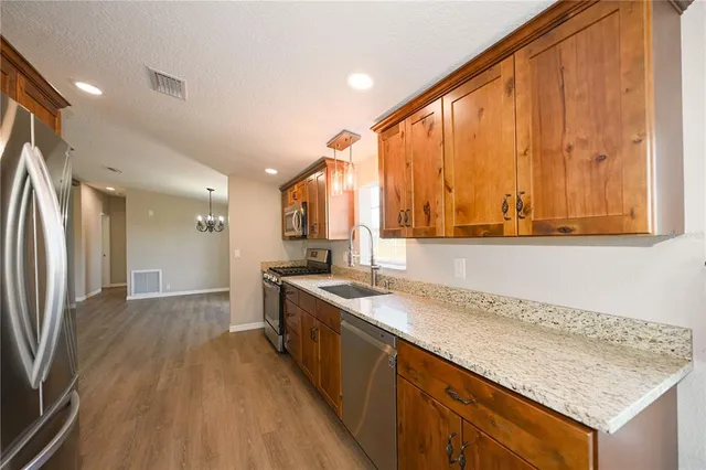 a cabinet with a view of kitchen and wooden floor