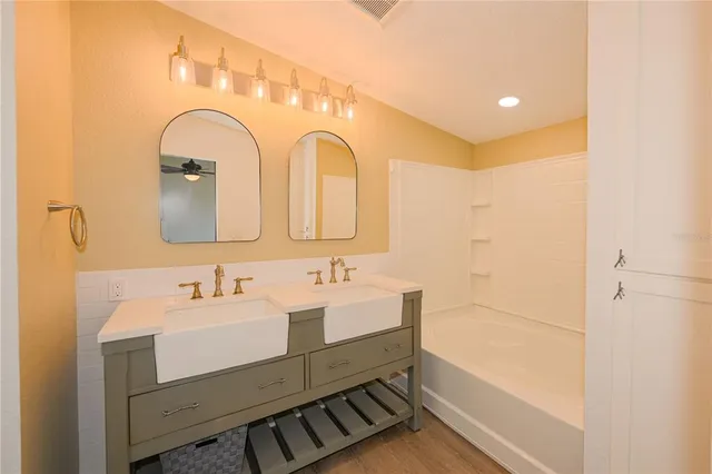 an empty room with a window and a ceiling fan