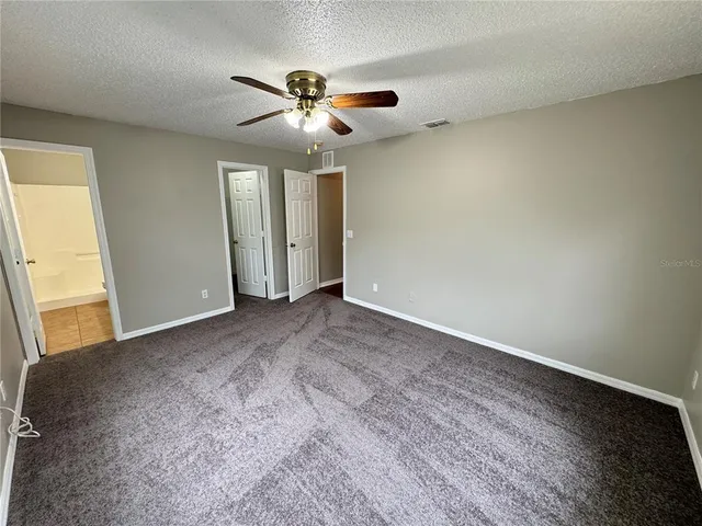 a view of a livingroom with a ceiling fan and window