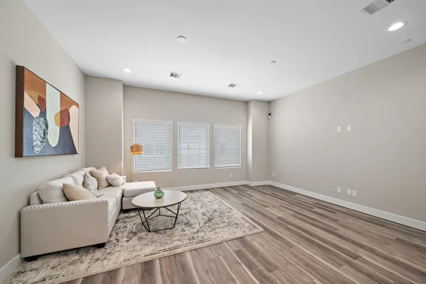 a living room with furniture and wooden floor
