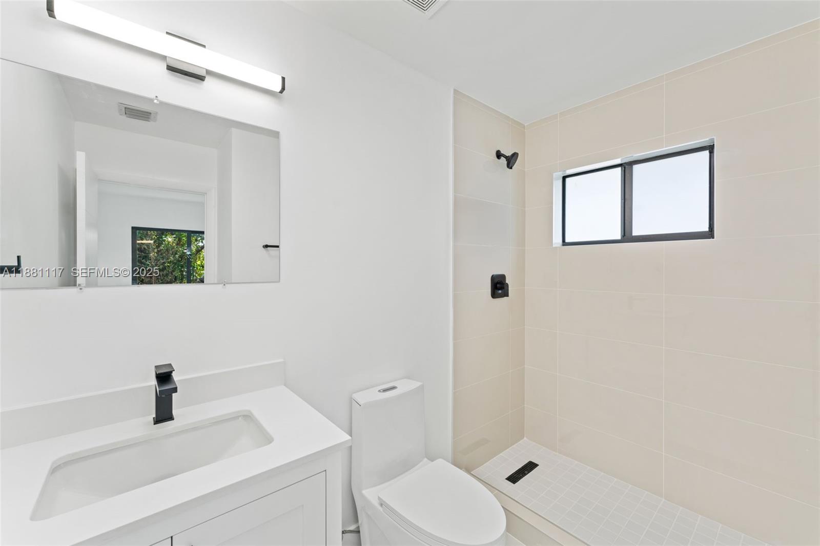 1556 Northwest 68th Terrace Miami, FL 33147 - Photo 11 of 14 a bathroom with a sink a toilet and shower