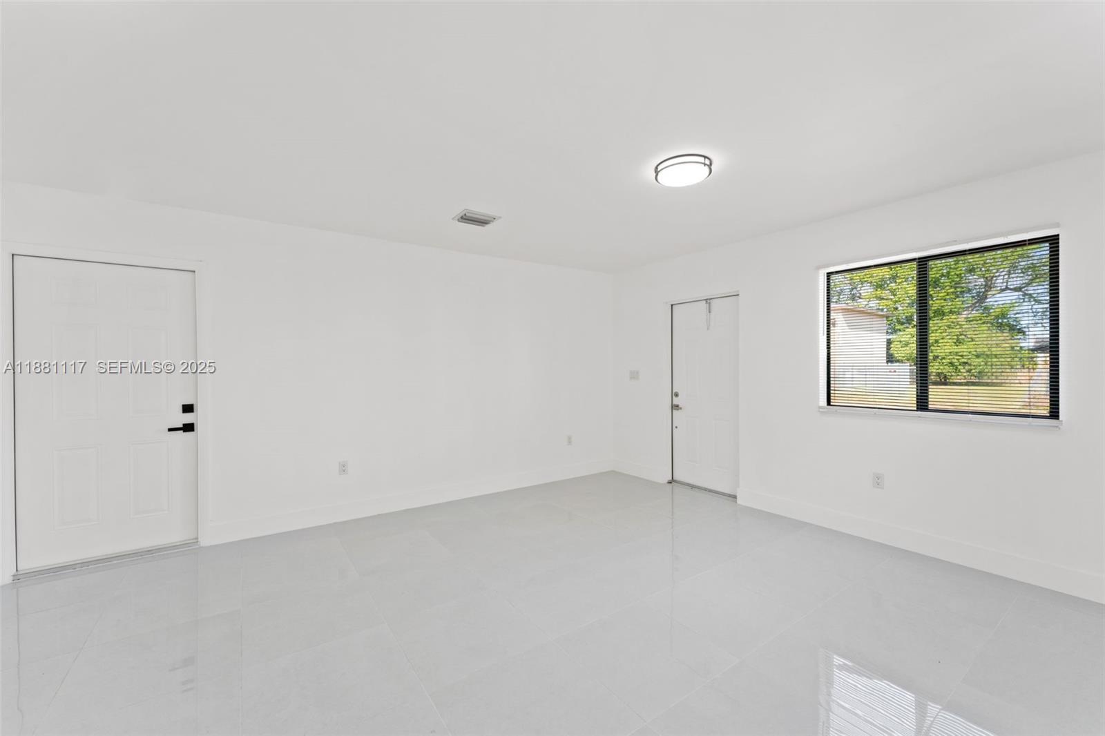 1556 Northwest 68th Terrace Miami, FL 33147 - Photo 5 of 14 an empty room with windows