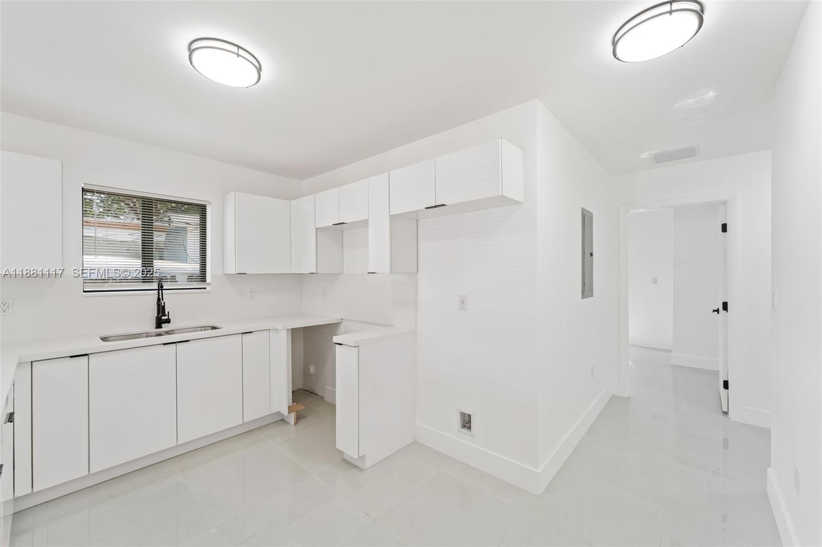 1556 Northwest 68th Terrace Miami, FL 33147 - Photo 6 of 14 a bathroom with a double vanity sink and mirror