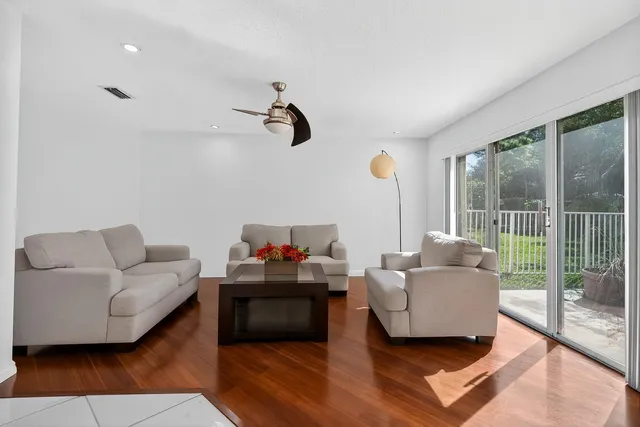 a view of a room with wooden floor and glass door