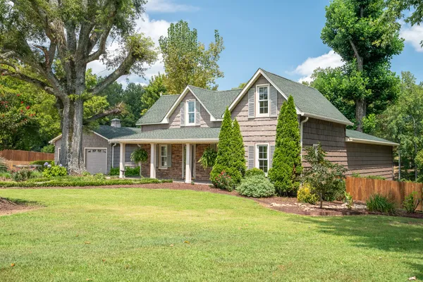 a front view of house with yard and green space